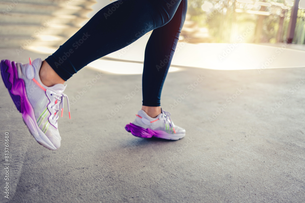 Runner athlete, woman and feet on pavement with blurred background ready for fitness and exercise. Road, run shoes and training of a female person outdoor for sports, race and marathon. Runner athlete, woman and feet on pavement with blurred background ready for fitness and exercise. Road, run shoes and training of a female person outdoor for sports, race and marathon.