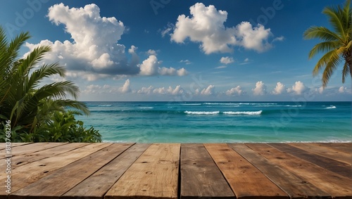 Summer tropical sea with waves, palm leaves and blue sky with clouds. Perfect vacation landscape with empty wooden table