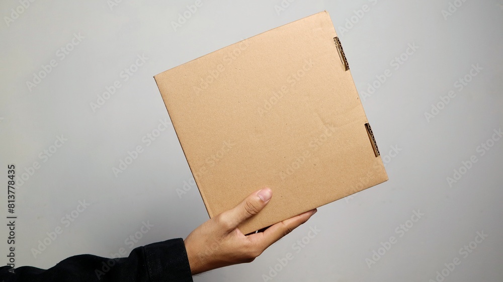 a man's hand holding a package a man's hand holding a package