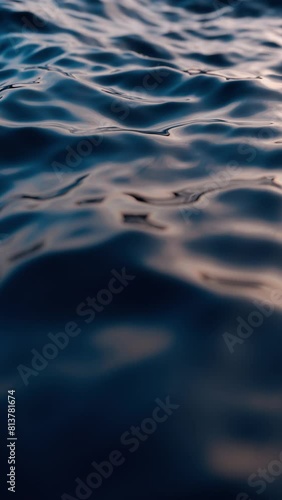 Close-up of a sea wave from a low angle, slow-motion sunrise or a vertical looping animation of a sunset.