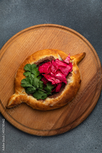 Traditional georgian khachapuri with red cabbage on wooden board