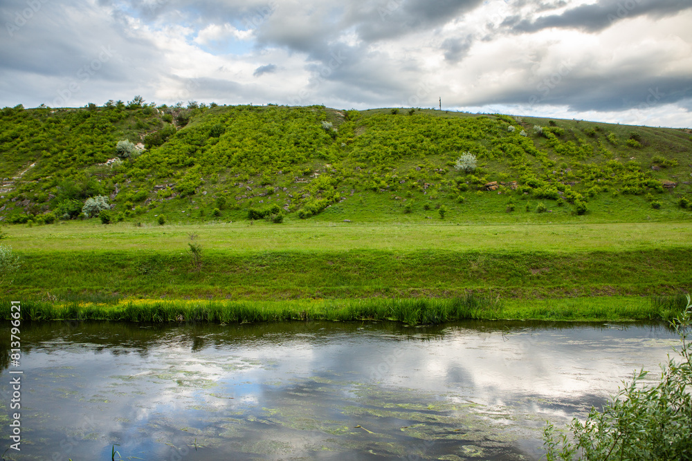 Beautiful summer landscape with green trees, green meadows on the bank of the river in Republic of Moldova. Beautiful summer landscape with green trees, green meadows on the bank of the river in Republic of Moldova.