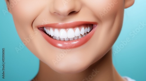 Close up of a beautiful young woman smiling with healthy white teeth on a blue background
