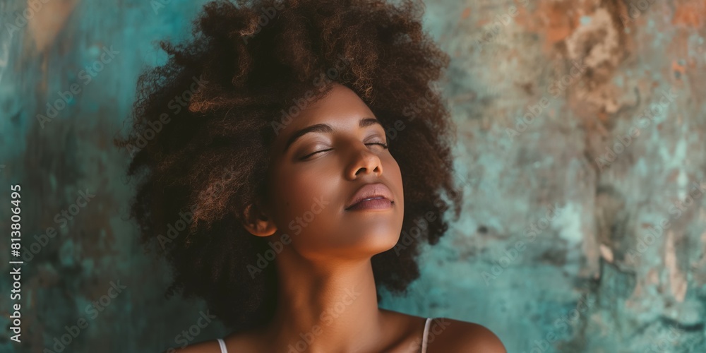 A serene black woman with a voluminous afro gently closes her eyes against a textured backdrop A serene black woman with a voluminous afro gently closes her eyes against a textured backdrop