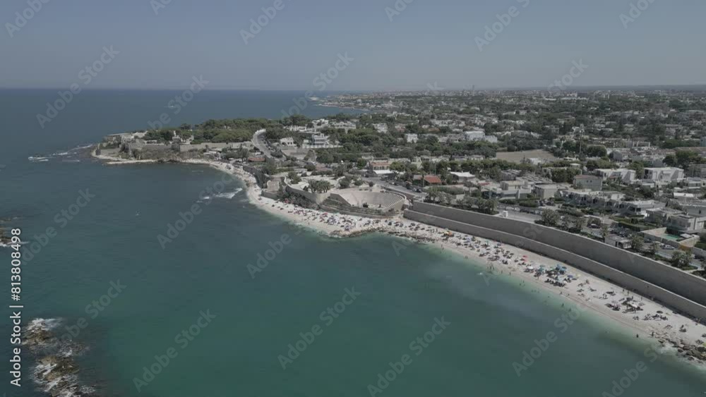 Top view, splendid aerial view of some people relaxing on a beautiful beach washed by the sea. Bisceglie (Apulia, Italy) Top view, splendid aerial view of some people relaxing on a beautiful beach washed by the sea. Bisceglie (Apulia, Italy)