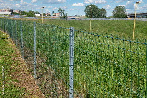Bild auf Leinwand Border fence in a field with galvanized steel pole and electro-welded rectangular mesh mesh