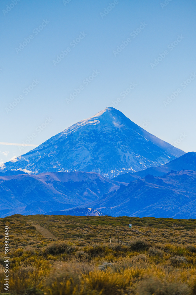 Lanin volcano surrounded by clouds, clear summit in sight and ice glaciers, between Argentina and Chile, Lanin National Park Lanin volcano surrounded by clouds, clear summit in sight and ice glaciers, between Argentina and Chile, Lanin National Park