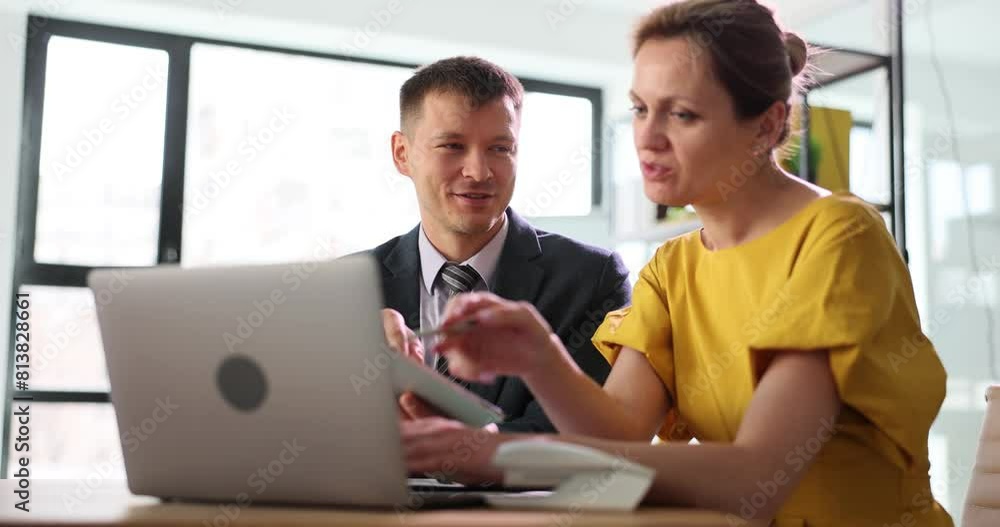 Two hired managers are discussing a business project talking in office, using tablet computer. Woman boss manager training new employee and trainee Two hired managers are discussing a business project talking in office, using tablet computer. Woman boss manager training new employee and trainee