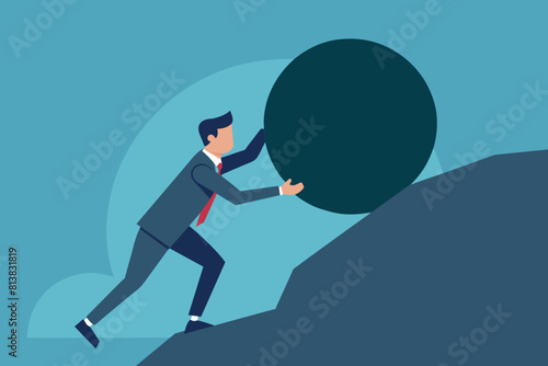 The concept of business problems in achieving success. A man in a business suit pushes a large stone-shaped volun uphill on a cliff