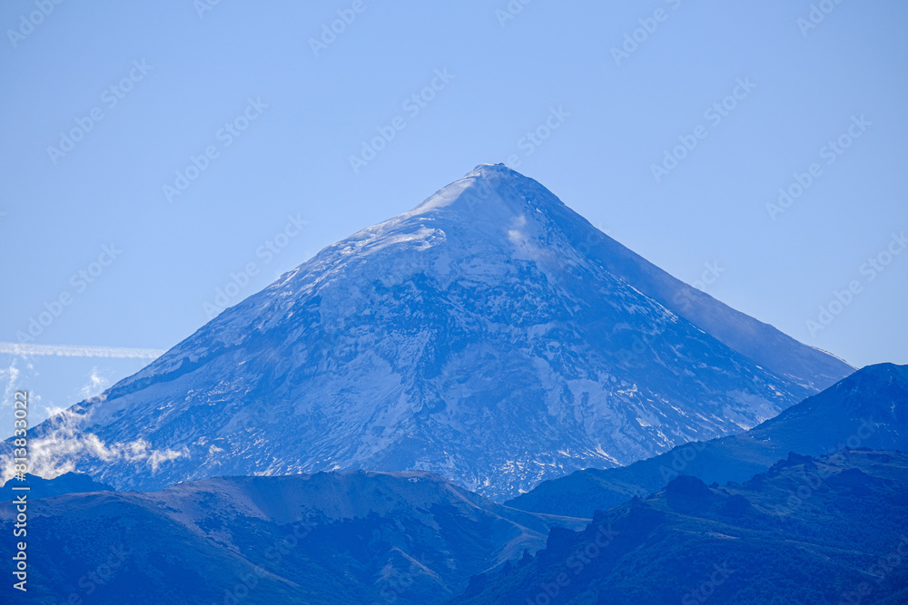 Lanin volcano surrounded by clouds, clear summit in sight and ice glaciers, between Argentina and Chile, Lanin National Park Lanin volcano surrounded by clouds, clear summit in sight and ice glaciers, between Argentina and Chile, Lanin National Park