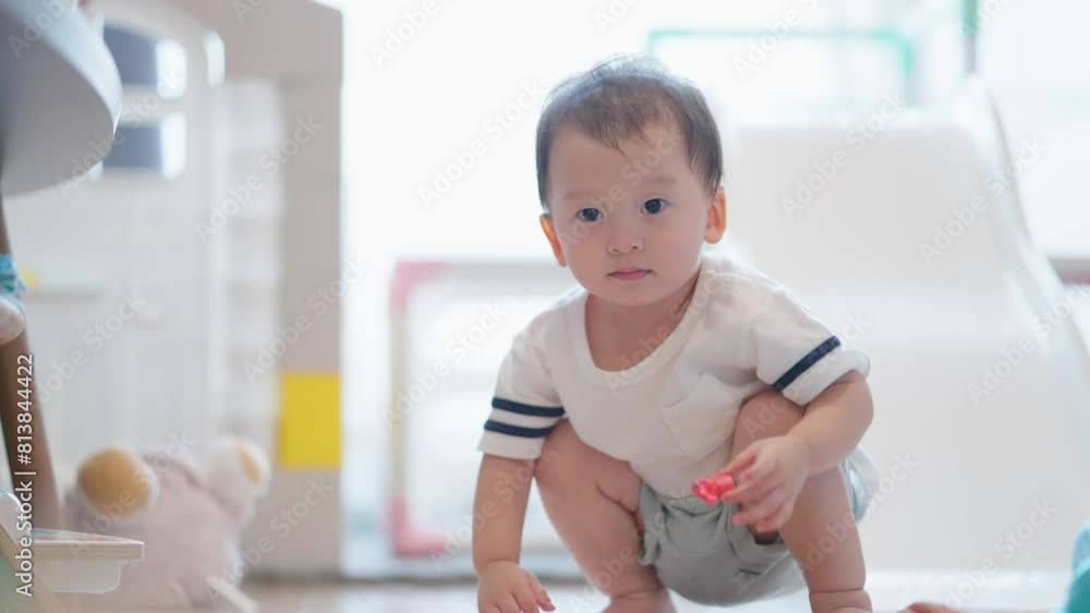 Cute two years old asian toddler sit down on the livingroom floor playing with colourful dry clay family bond with innocent new born baby, family love and support, children curiosity learning skills Cute two years old asian toddler sit down on the livingroom floor playing with colourful dry clay family bond with innocent new born baby, family love and support, children curiosity learning skills
