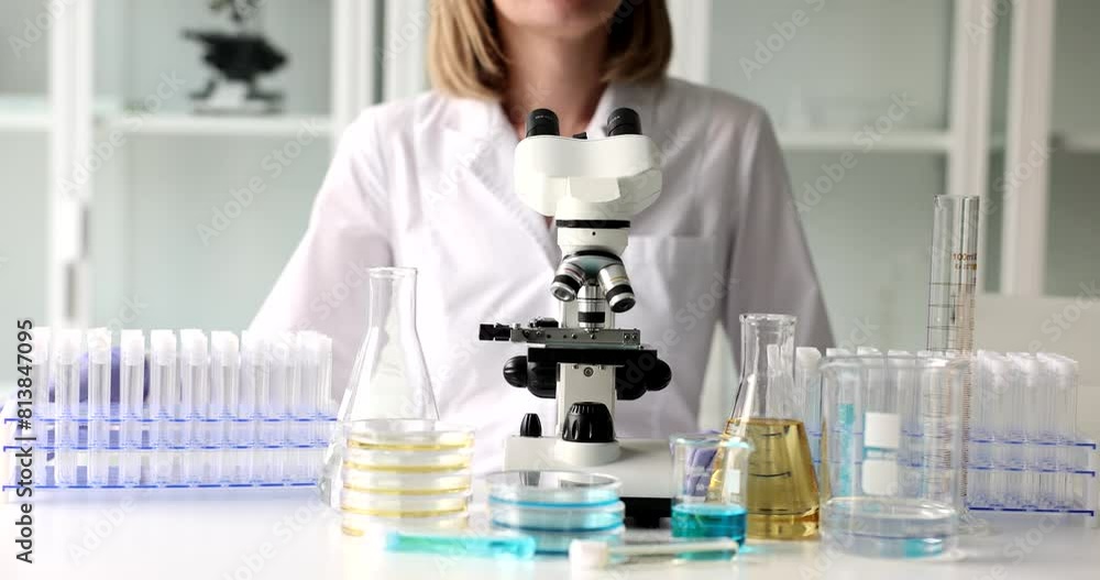 Scientist doctor biologist sit down at workplace in laboratory. Scientific research and chemical analysis of toxic substances Scientist doctor biologist sit down at workplace in laboratory. Scientific research and chemical analysis of toxic substances