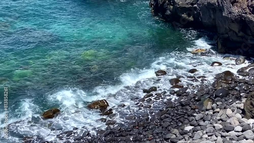 The Atlantic Ocean blue transparent water and pebble coast  in the north of Tenerife near Buenavista del Norte,  Canary Islands,Spain. photo