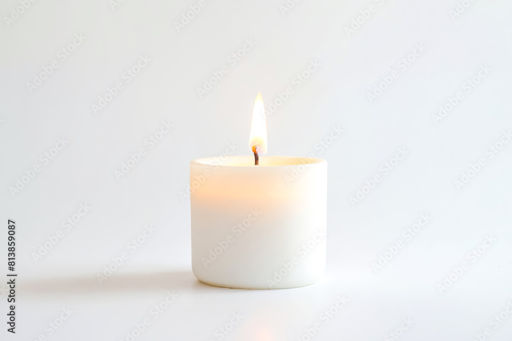 White Candle Burning on a White Background