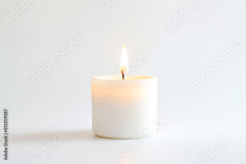 White Candle Burning on a White Background