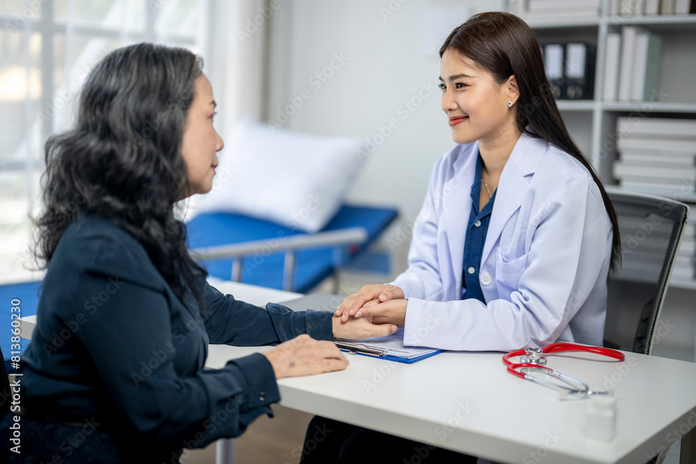 A woman is sitting at a desk with a doctor A woman is sitting at a desk with a doctor