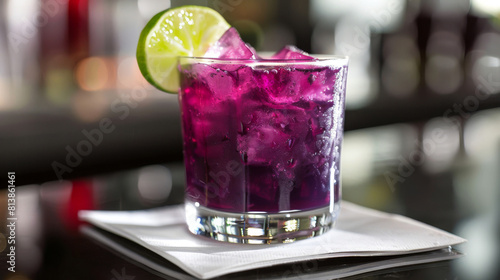 Refreshing glass of chicha morada, made from peruvian purple corn, garnished with a lime slice, served on a bar counter photo