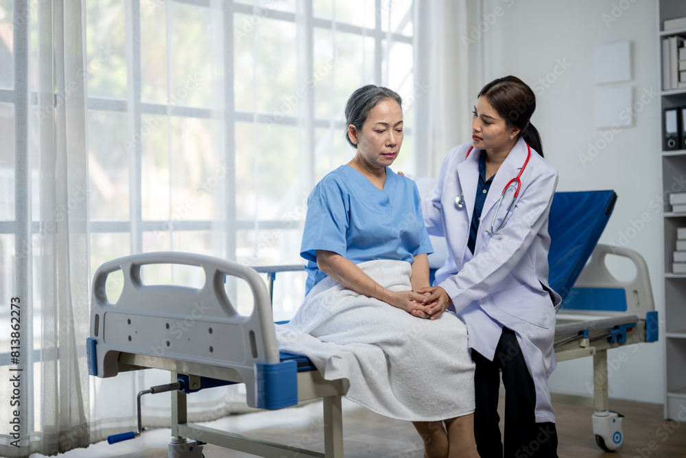 A woman in a hospital bed is being comforted by a doctor A woman in a hospital bed is being comforted by a doctor