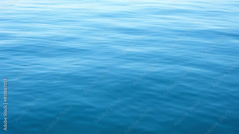 Continuously changing deep blue sea or ocean surface for a background. Beautiful fresh wavy water on a cloudy afternoon. Calm and meditative nature concept. Abstract minimalistic slow motion. Continuously changing deep blue sea or ocean surface for a background. Beautiful fresh wavy water on a cloudy afternoon. Calm and meditative nature concept. Abstract minimalistic slow motion.
