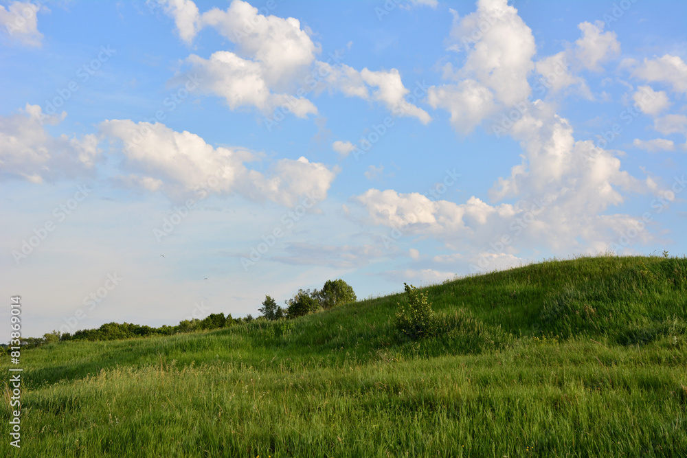 a field with a sky and white clouds in sunset a field with a sky and white clouds in sunset