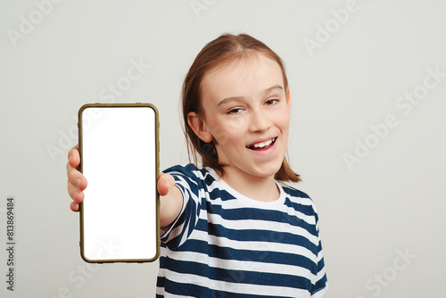 Excited young guy holding smartphone with white blank screen in hand. Gadget with empty free space for mock up.