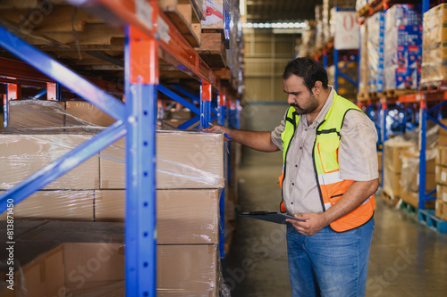 Industry warehouse managers in safety uniforms check the stock order details and goods supplies in the workplace warehouse. industry logistic export import distribution concept.