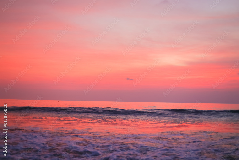 Beautiful pink sunset and clouds over the ocean. Delicate peach sunset background