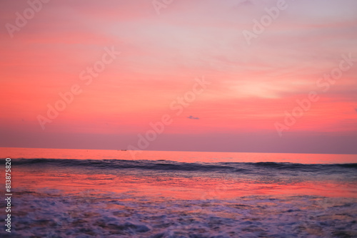 Beautiful pink sunset and clouds over the ocean. Delicate peach sunset background