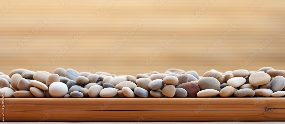 A wooden table is positioned on a bamboo mat contrasting with the texture of pebbles in the background The composition presents a copy space image A wooden table is positioned on a bamboo mat contrasting with the texture of pebbles in the background The composition presents a copy space image