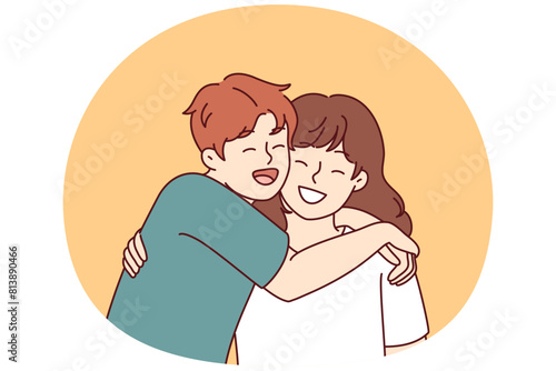 Positive little boy and girl hugging and laughing enjoying spending time together or summer vacation. Concept of happy childhood and friendship between classmates or little brother and sister