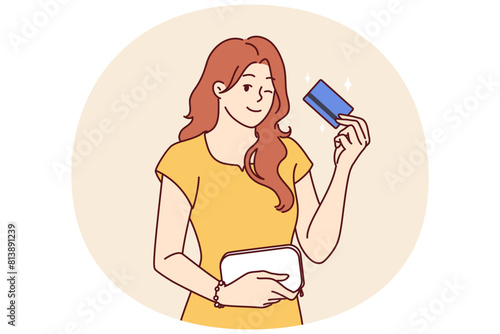 Woman with bank card winking recommend using reliable banking or credit product with large cashback. girl shows credit card intended for bargain purchases or cash withdrawals from ATM