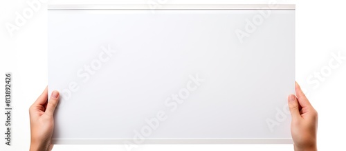 A person s hand securely grips a blank white message board providing ample space for text The background is isolated drawing attention to the copy space image photo