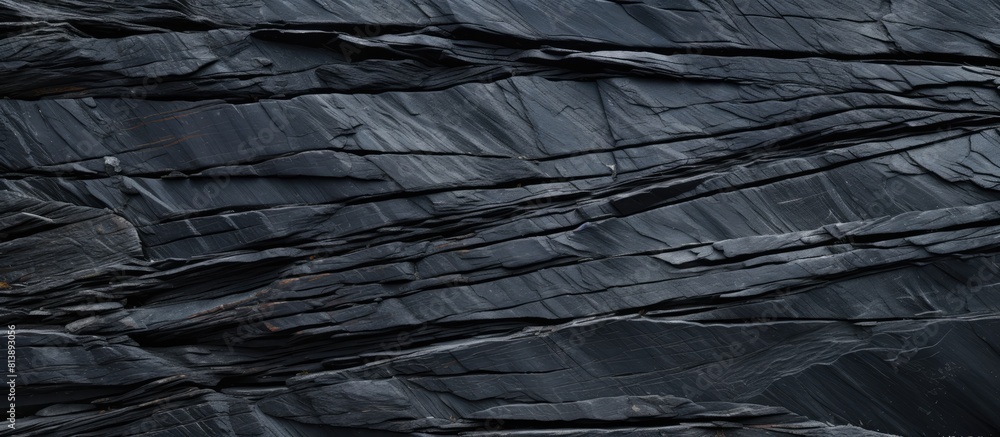 A top down view of a black slate stone texture creates a surface background with ample copy space for images A top down view of a black slate stone texture creates a surface background with ample copy space for images