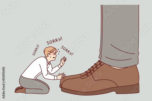 Unhappy business man asks sorry to boss, kneeling near feet of big director of corporation. Guy is humiliated and says sorry to ceo of company, out of fear of bankruptcy and unemployment.