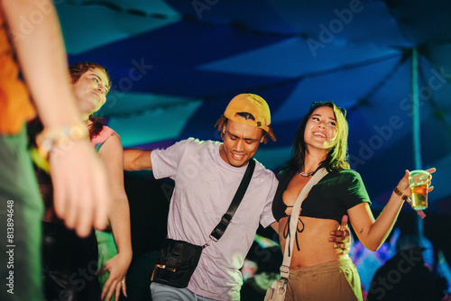 Group of friends dancing to the beats at a summer festival photo