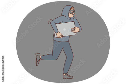 Male robber in mask steal computer