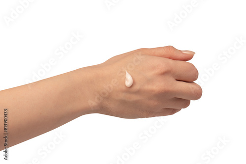 Beige cream tube in woman hands isolated on a white background. Cream swatch on woman hand.