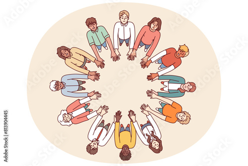 Friendly people stand in circle hold hands for collaboration and teamwork, top view. University students of different gender and race get education together while studying in college