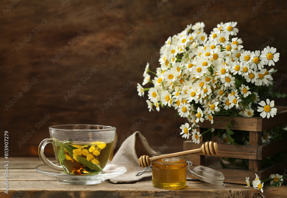 cup of herbal tea and a bouquet of chamomile flowers cup of herbal tea and a bouquet of chamomile flowers