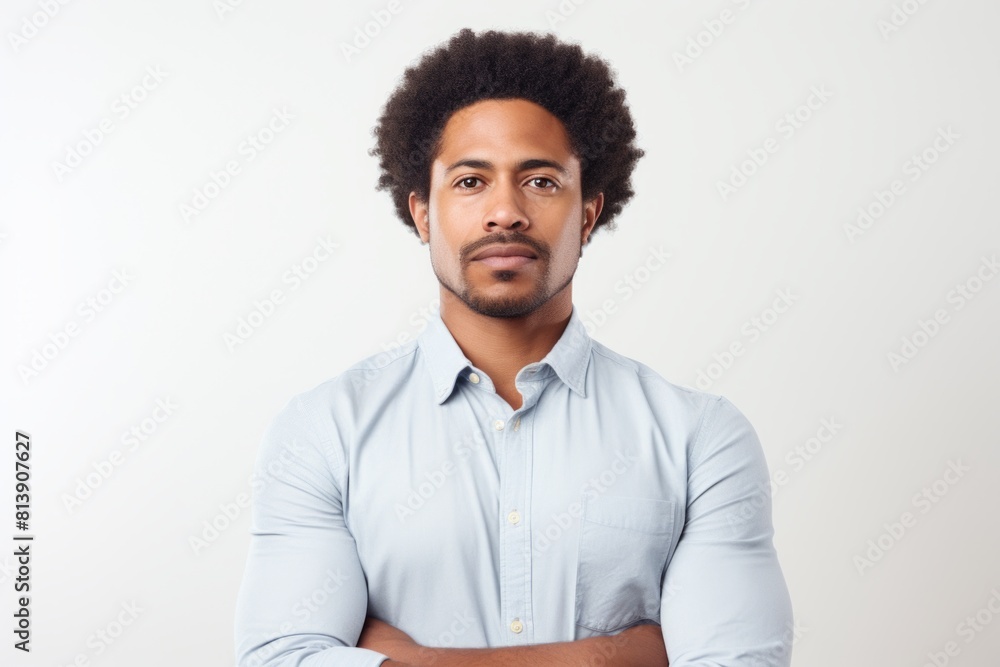 Portrait of a tender afro-american man in his 30s with arms crossed in front of white background Portrait of a tender afro-american man in his 30s with arms crossed in front of white background
