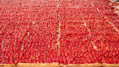 Thousands of glazed strawberries on a giant 30m long strawberry tart at the 25th annual strawberry fair, "Foire de la Fraise", at Nabirat in the Dordogne region of France
