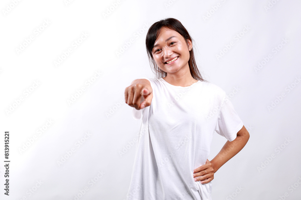 Beautiful young asian woman standing pointing finger at camera and smiling, choosing, inviting people, recruiting. Isolated on white background Beautiful young asian woman standing pointing finger at camera and smiling, choosing, inviting people, recruiting. Isolated on white background