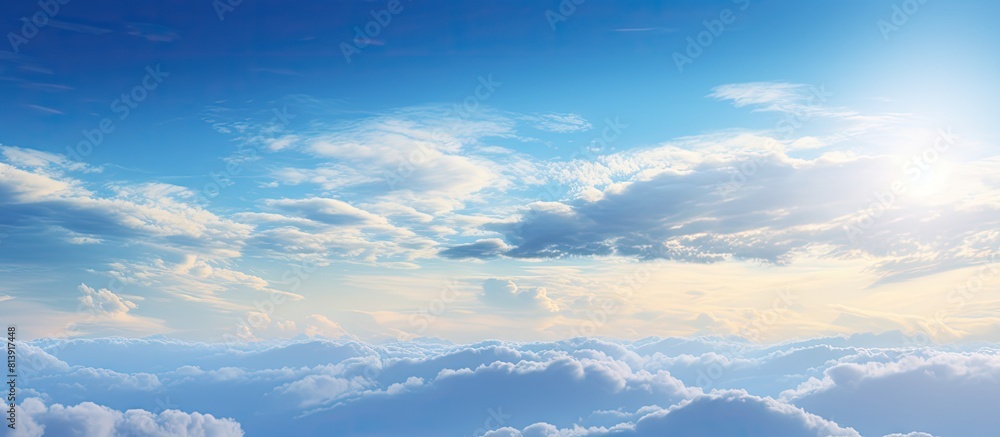 Obraz premium In the morning a stunning sunrise illuminates a lovely blue sky dotted with a group of white fluffy clouds creating a picturesque natural background for a copy space image