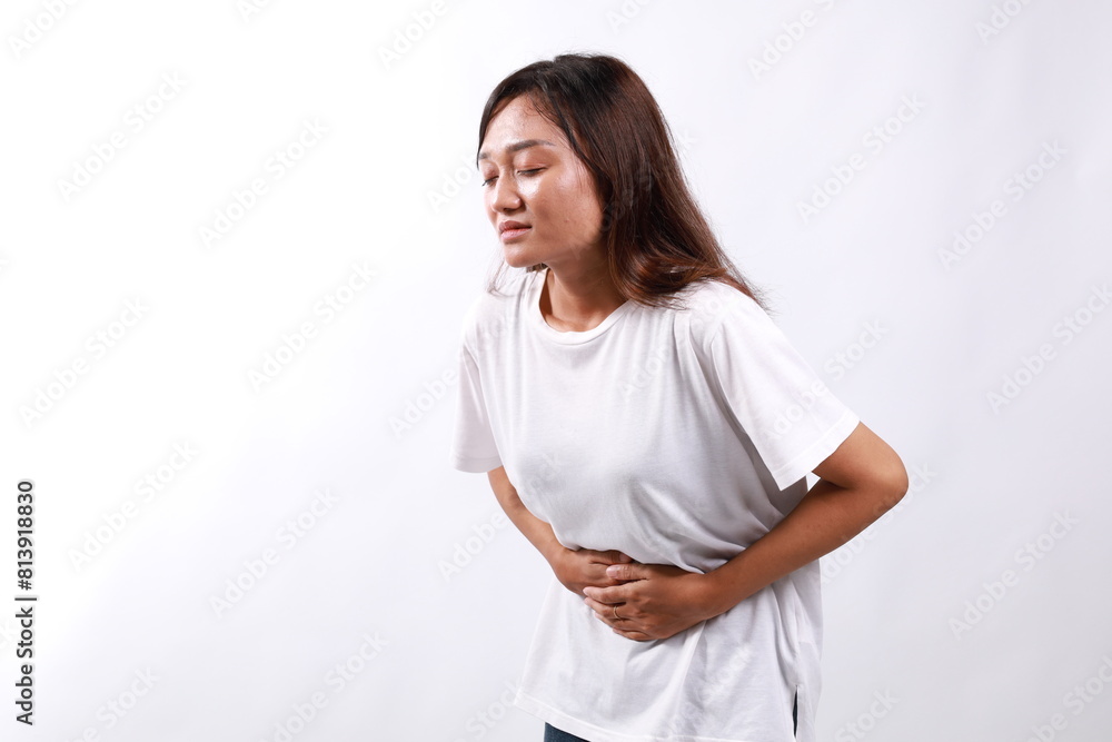 Young asian Woman has stomachache isolated over white background with copyspace Young asian Woman has stomachache isolated over white background with copyspace
