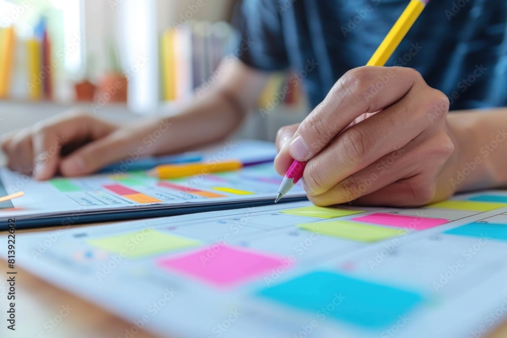 A person sitting at a desk with a pen and paper. Suitable for office or education concepts A person sitting at a desk with a pen and paper. Suitable for office or education concepts