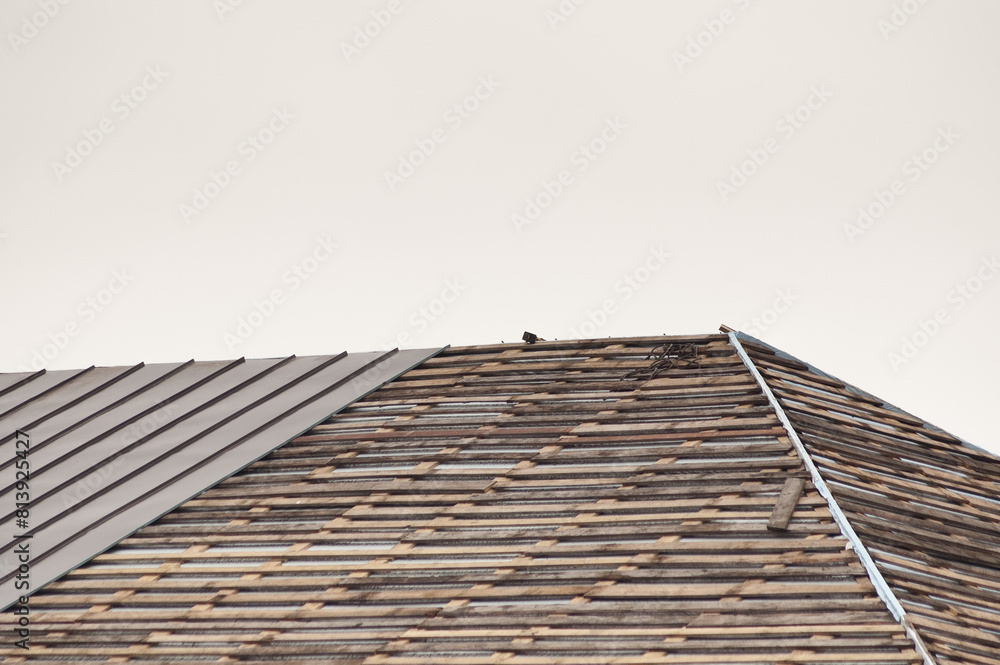 new roof of a building against a background of gray sky new roof of a building against a background of gray sky