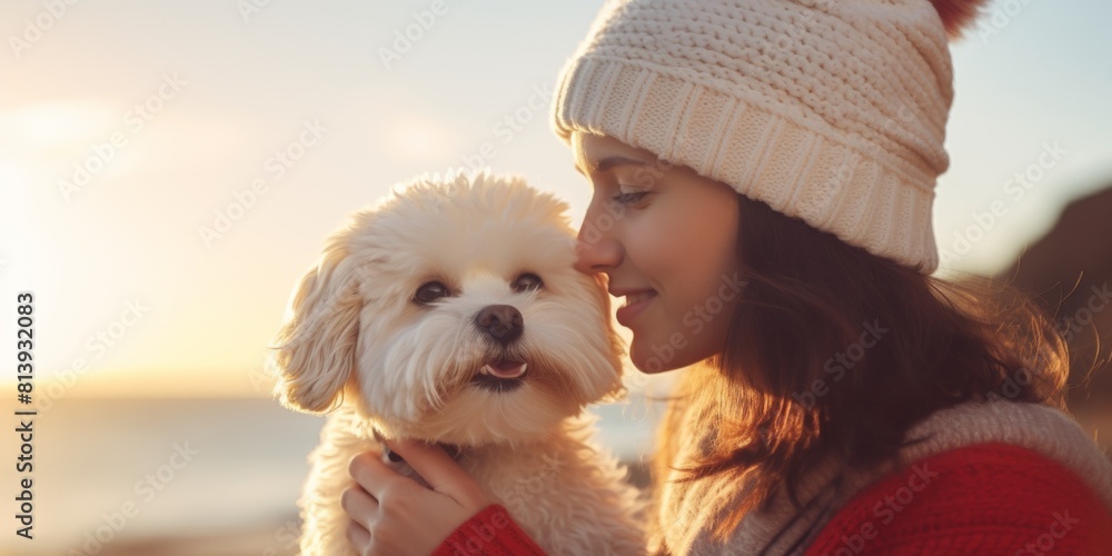 Happy young woman is sitting on the seashore on a sunny day and holding a dog in her arms. Generative AI. Happy young woman is sitting on the seashore on a sunny day and holding a dog in her arms. Generative AI.