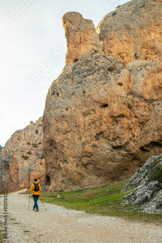 Person walking next to a large rock formation in the Sierra de Albarracín. © Alejandro Vicente