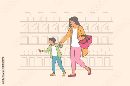 Mother and child shop in supermarket, passing shelves with assortment of cleaning products