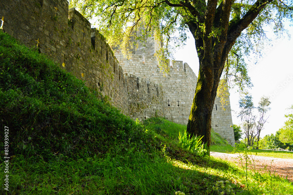 A medieval castle on a bright sunny day. Walls and towers of an ancient castle in Portugal during a tourist walk in a Portuguese town A medieval castle on a bright sunny day. Walls and towers of an ancient castle in Portugal during a tourist walk in a Portuguese town